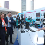 Participants interact with an AI-enabled robot during the Summer Davos Forum in Dalian, Liaoning province. ZOU HONG/CHINA DAILY