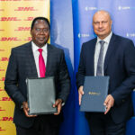 DHL Express Kenya MD Paul Makolosi (left) and SBM Bank Kenya CEO Bhartesh Shah (right) pose after signing a strategic partnership MOU to support SME growth in international export trade.