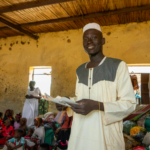 Ibrahim Abdulrahman inside the classroom he shares with dozens of other forcibly displaced families in Kosti in Sudan's While Nile State.