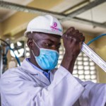 A worker secures the supply line on an oxygen tank at the Hewatele oxygen plant in Nairobi, Kenya, on April 13, 2021