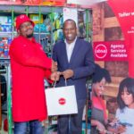 Absa Bank Kenya MD and CEO Abdi Mohamed presents a gift to Absa Bank Ruaka agent Sammy Njoroge during the launch of Absa Bank agency banking expansion drive. The bank is targeting to expand its agency banking network to 17,000 outlets within the next two years.